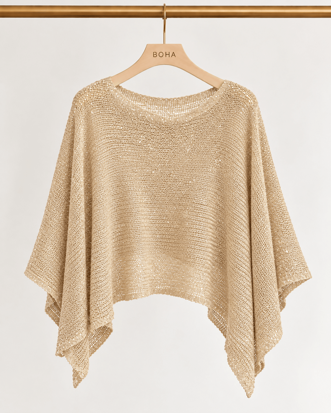 Poncho Jasmim dourado de malha brilhante, bainha assimétrica e poncho amplo